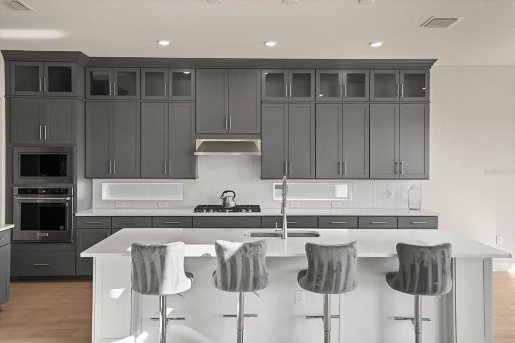 8352 Pk Clf Way Orlando, FL 32836 - Photo 11 of 55 a kitchen with cabinets and chairs