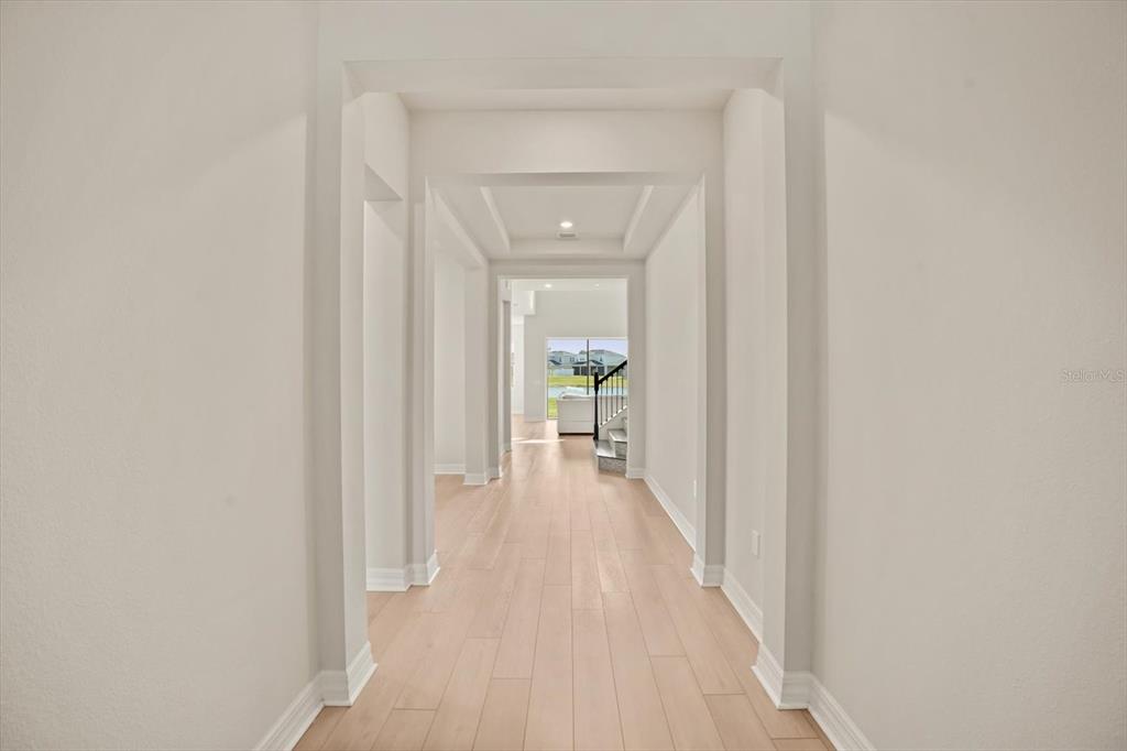 8352 Pk Clf Way Orlando, FL 32836 - Photo 16 of 55 a view of a hallway with wooden floor and a bathroom