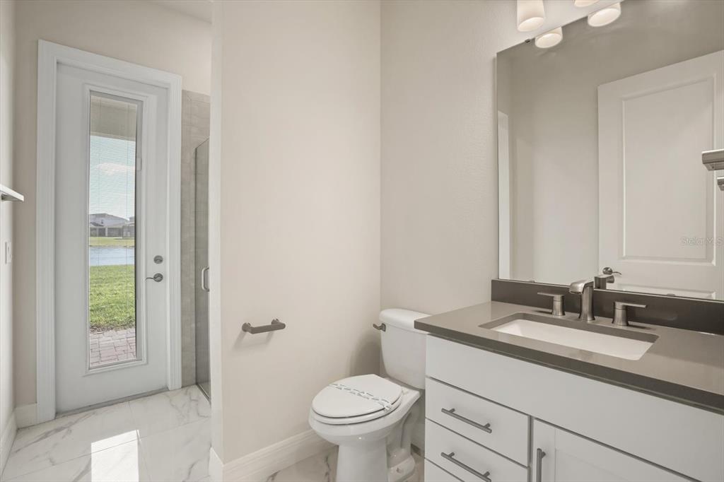 8352 Pk Clf Way Orlando, FL 32836 - Photo 22 of 55 a bathroom with a granite countertop toilet a sink and a mirror