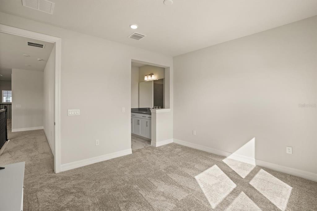 8352 Pk Clf Way Orlando, FL 32836 - Photo 36 of 55 an empty room with wooden floor and a bathroom
