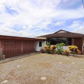 a view of a house with a yard and sitting area