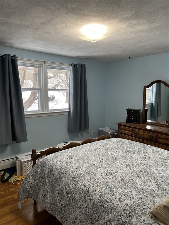 38 Chevy Chase Road Worcester, MA 01606 - Photo 18 of 35 a bedroom with a bed and a flat tv screen on the dresser