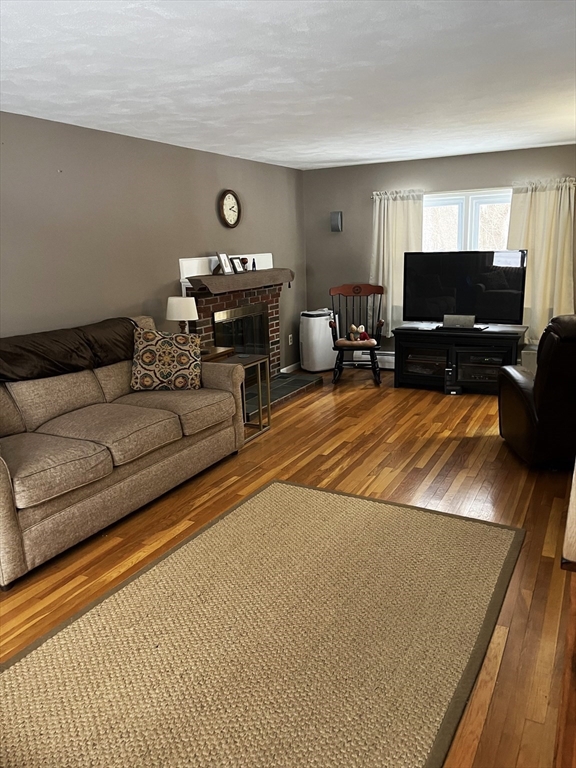 38 Chevy Chase Road Worcester, MA 01606 - Photo 3 of 35 a living room with furniture a flat screen tv and a fireplace