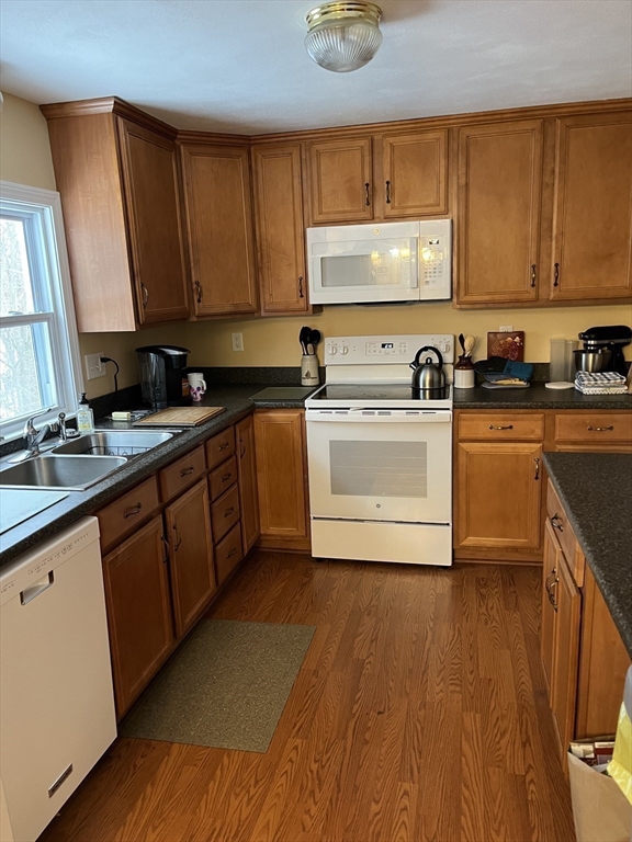 38 Chevy Chase Road Worcester, MA 01606 - Photo 10 of 35 a kitchen with stainless steel appliances granite countertop a stove a sink dishwasher and a microwave oven with wooden floor