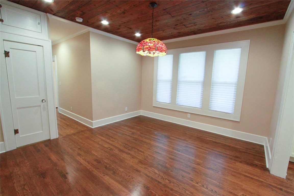 1301 South 6th Street Austin, TX 78704 - Photo 14 of 35 a view of an empty room with wooden floor and windows