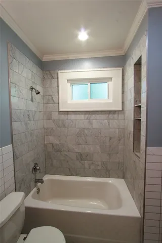 a bathroom with a bathtub and toilet