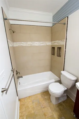 a bathroom with a toilet and a shower