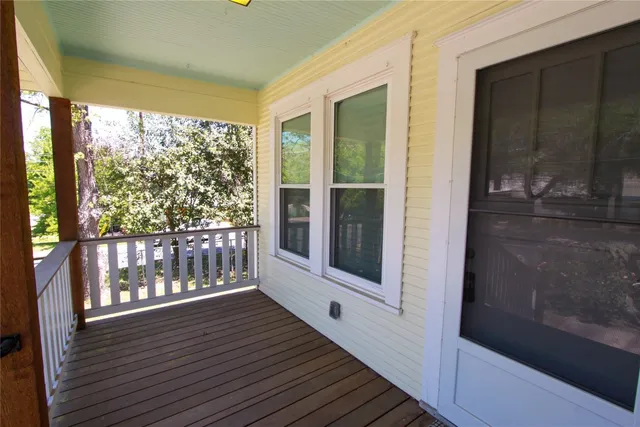 a view of a balcony with wooden floor