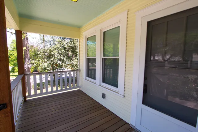 a view of a balcony with wooden floor