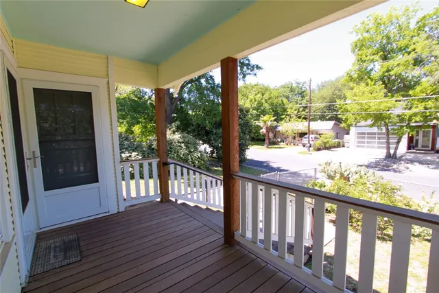a view of a porch with wooden floor