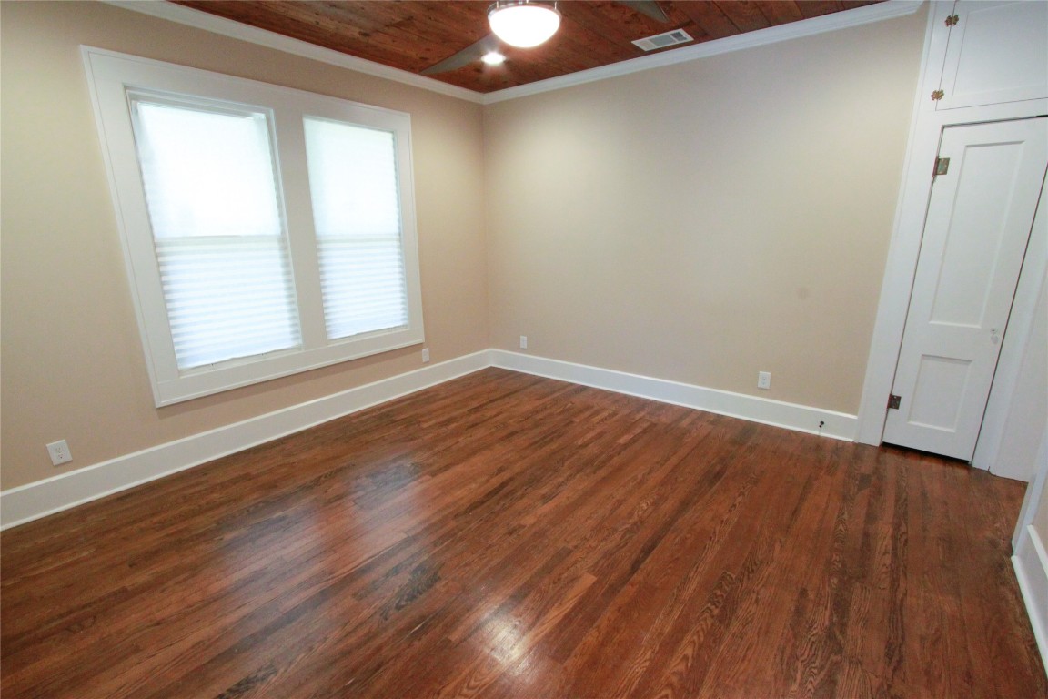 1301 South 6th Street Austin, TX 78704 - Photo 7 of 35 an empty room with wooden floor and windows