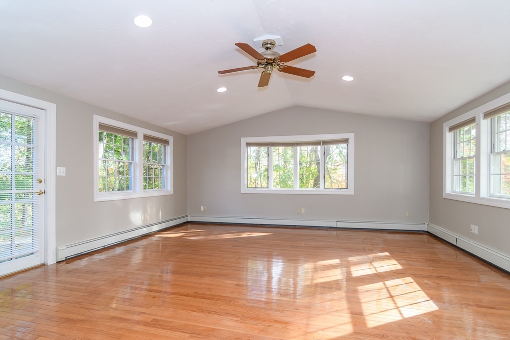 3 Hickory Lane, Unit 3 Framingham, MA 01701 - Photo 12 of 24 an empty room with wooden floor fan and windows