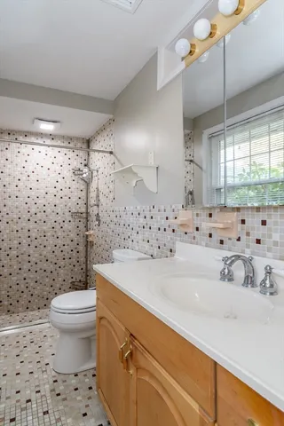 a bathroom with a sink a toilet and shower curtain