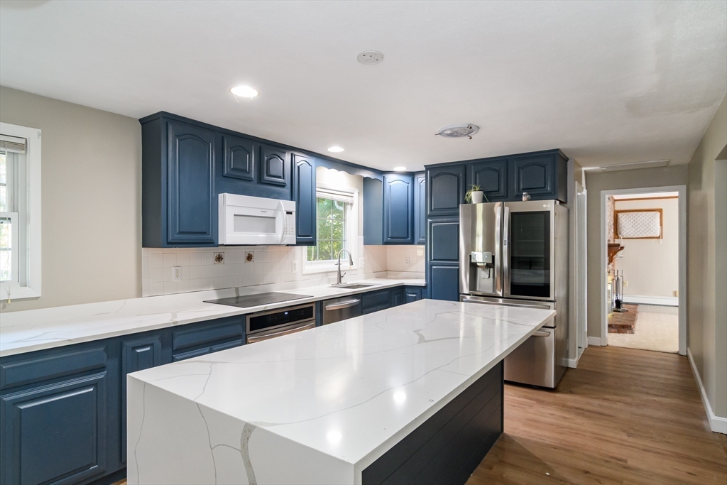 3 Hickory Lane, Unit 3 Framingham, MA 01701 - Photo 2 of 24 a large kitchen with stainless steel appliances a sink dishwasher stove and refrigerator