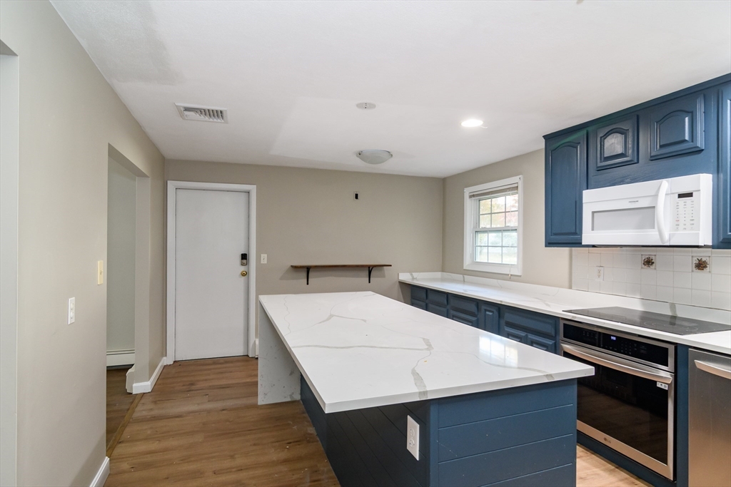 3 Hickory Lane, Unit 3 Framingham, MA 01701 - Photo 3 of 24 a kitchen with a sink a stove and cabinets