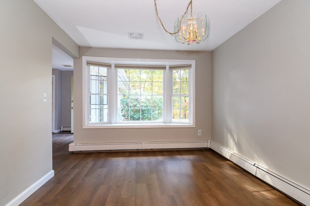 3 Hickory Lane, Unit 3 Framingham, MA 01701 - Photo 8 of 24 an empty room with wooden floor and windows