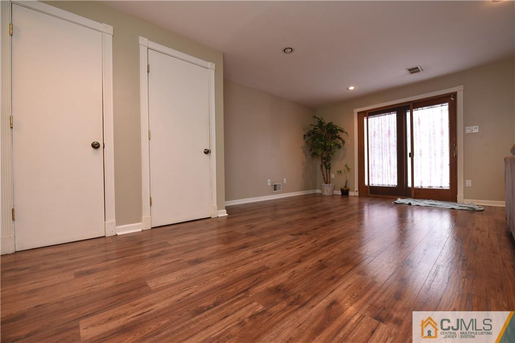 15 Dumas Road Old Bridge, NJ 08857 - Photo 4 of 15 a view of an empty room with wooden floor and a window