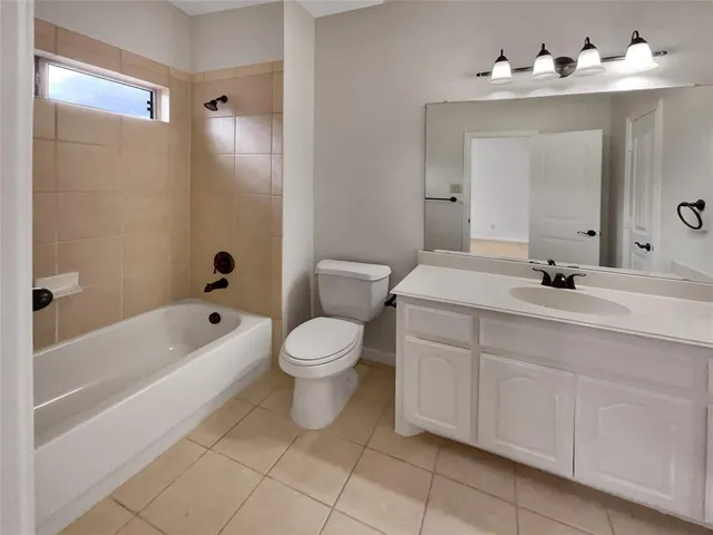 a bathroom with a sink vanity mirror and toilet