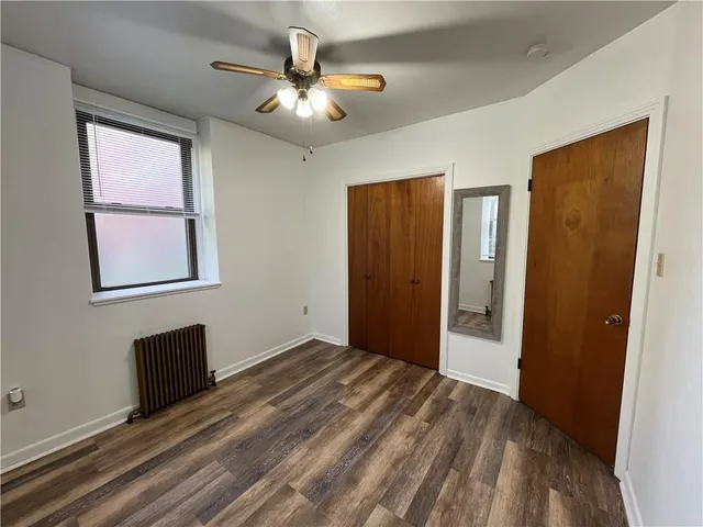 an empty room with windows and closet