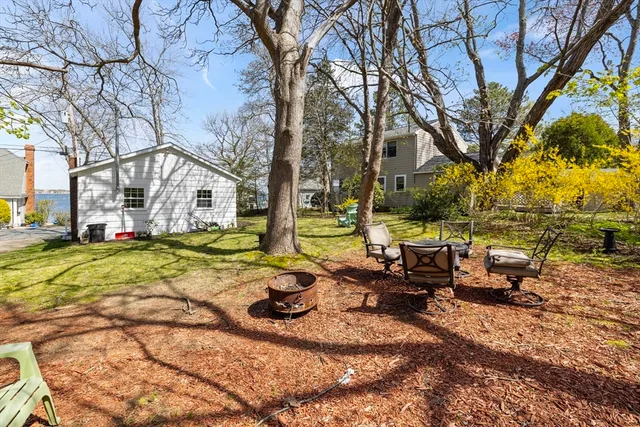 a view of a yard with chairs