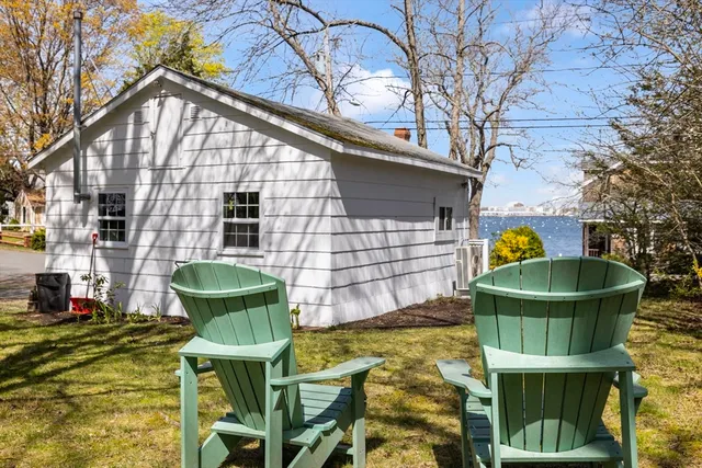 a backyard of a house with table and chairs