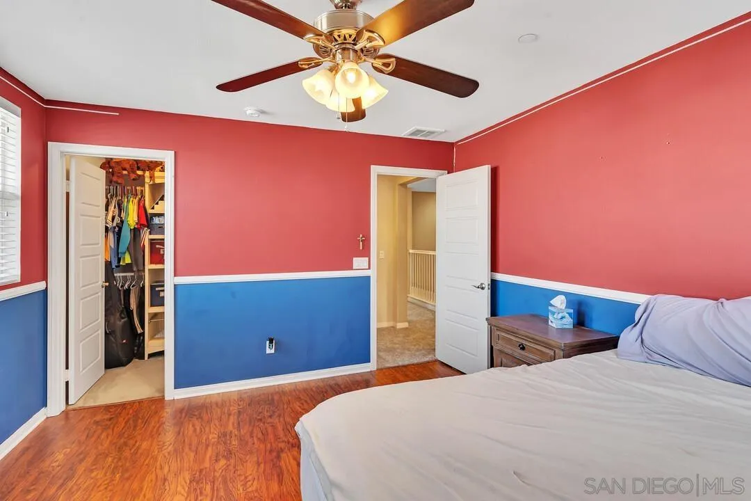 10057 Ranchitos Place Lakeside, CA 92040 - Photo 26 of 45 a bedroom with a bed and a chandelier