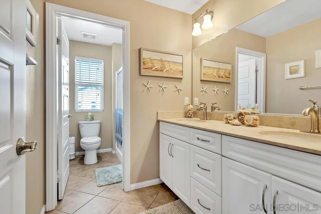 10057 Ranchitos Place Lakeside, CA 92040 - Photo 27 of 45 a spacious bathroom with a granite countertop toilet sink and a mirror
