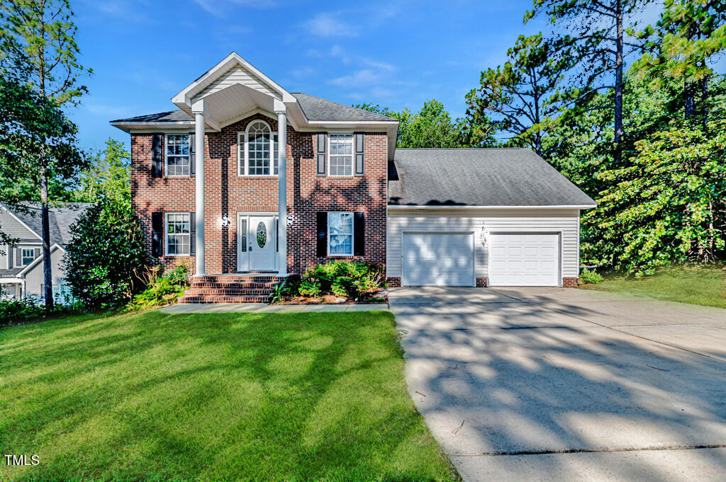 a front view of a house with a yard and garage