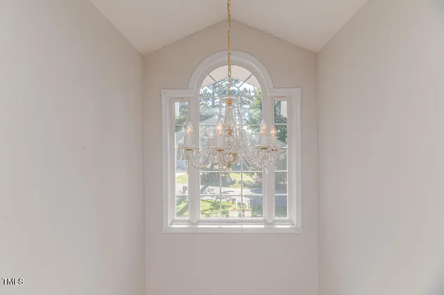 a view of a hallway with wooden floor and stairs
