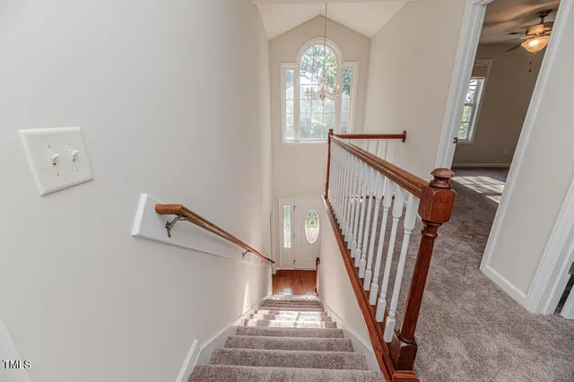 a view of a room with wooden floor and staircase