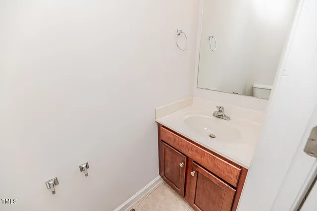 an empty room with windows and refrigerator