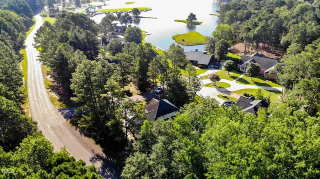 a aerial view of a house with a yard and swimming pool