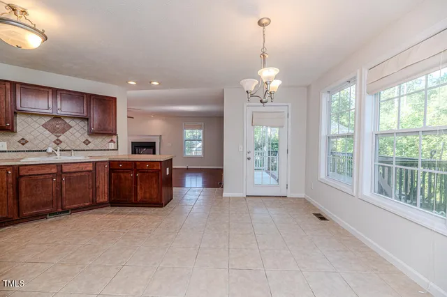 a kitchen with granite countertop wood cabinets and stainless steel appliances