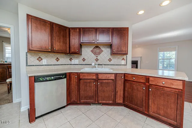 a view of kitchen with stainless steel appliances kitchen island granite countertop a stove a sink a refrigerator and a microwave