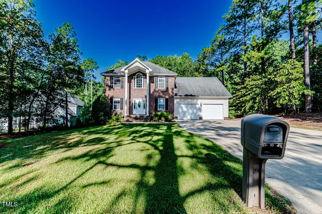 an aerial view of a house with garden space and street view