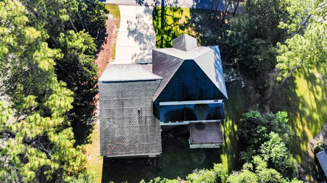 a aerial view of a house with swimming pool and ocean view