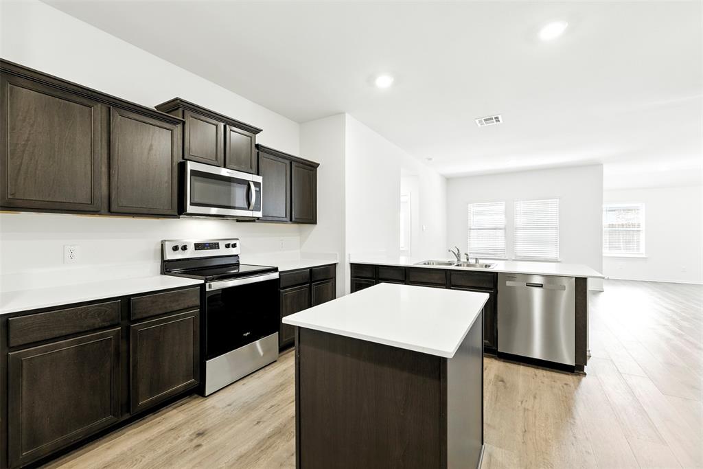 2808 Jasmine Drive Sherman, TX 75092 - Photo 11 of 38 a kitchen with a stove a sink and a microwave