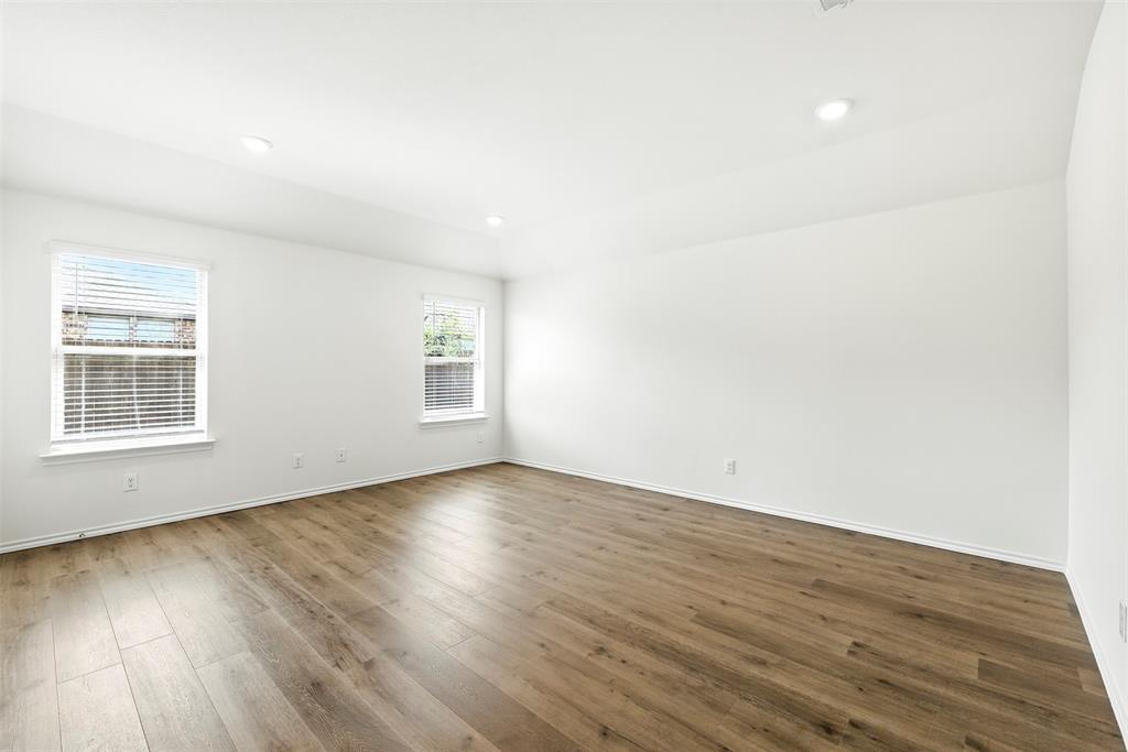 2808 Jasmine Drive Sherman, TX 75092 - Photo 15 of 38 a view of an empty room with wooden floor and a window
