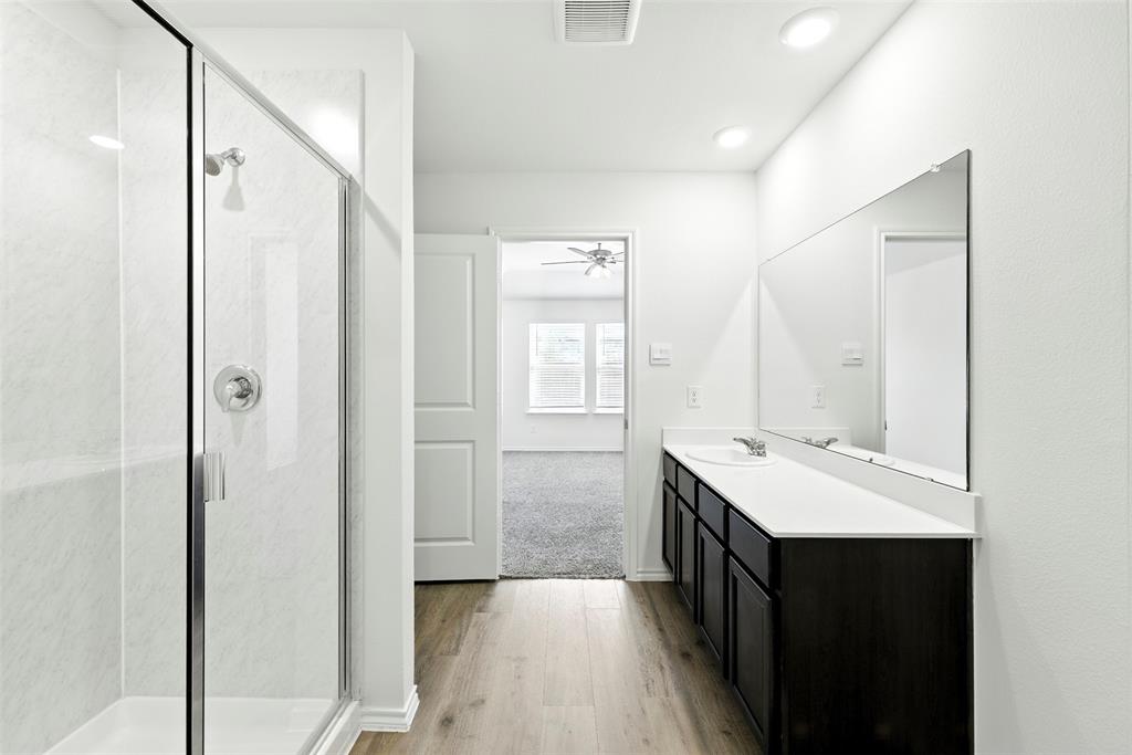 2808 Jasmine Drive Sherman, TX 75092 - Photo 17 of 38 a bathroom with a double vanity sink a mirror and a shower