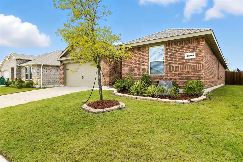 2808 Jasmine Drive Sherman, TX 75092 - Photo 2 of 38 a front view of a house with a yard