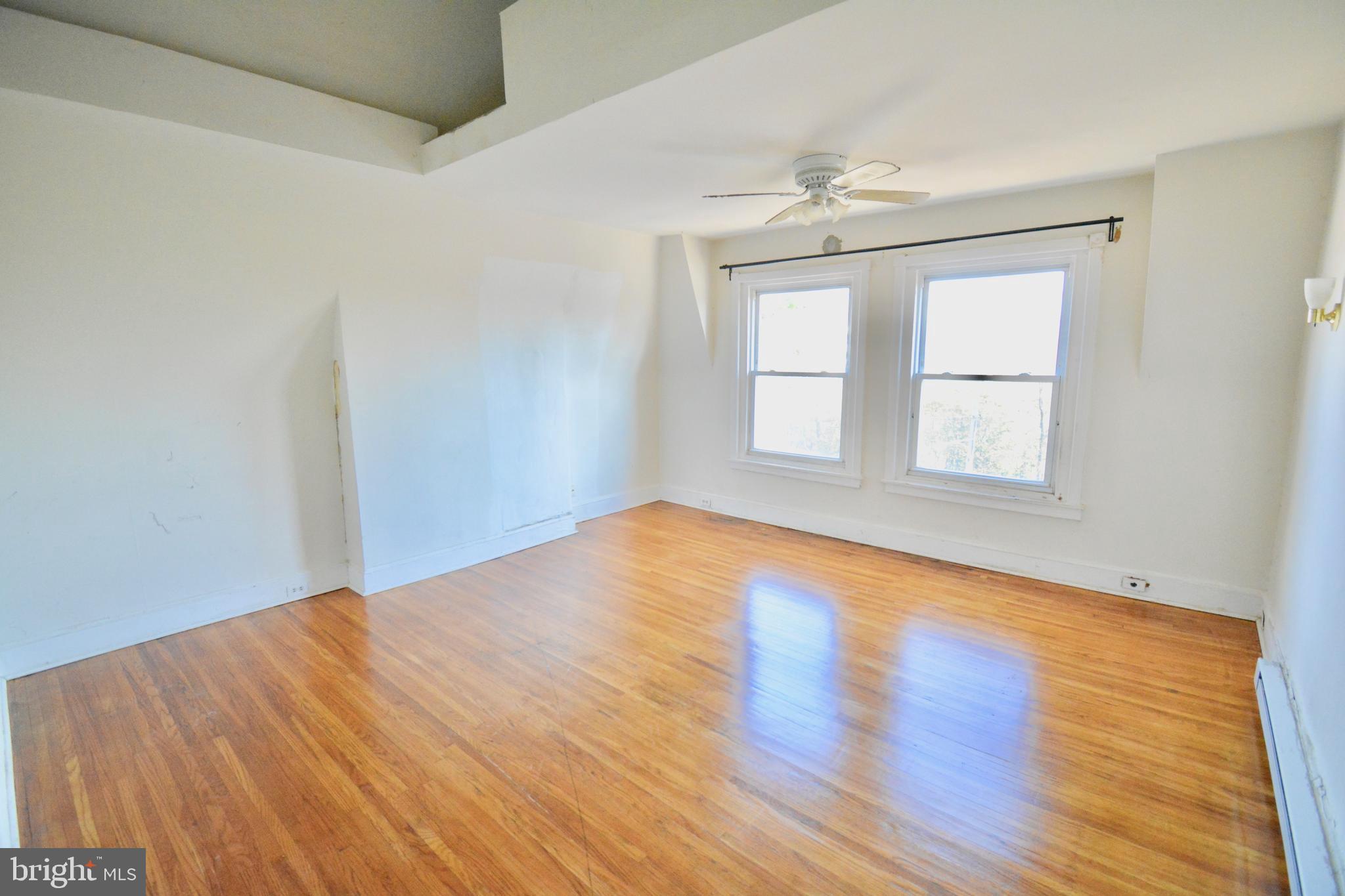 433 Hansberry Street, Unit 3 Philadelphia, PA 19144 - Photo 4 of 12 wooden floor in an empty room with a window