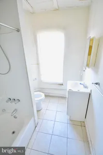 a bathroom with a shower and a window