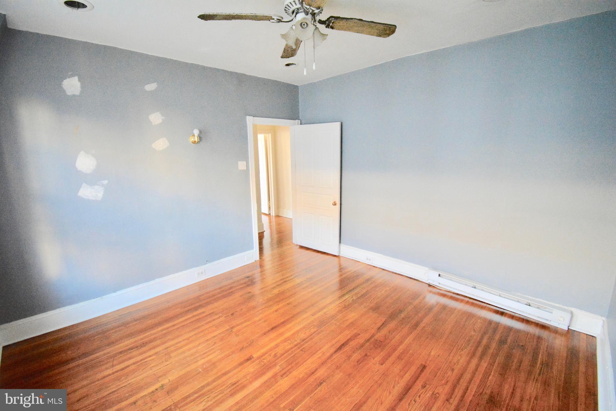 433 Hansberry Street, Unit 3 Philadelphia, PA 19144 - Photo 10 of 12 wooden floor in an empty room with a window