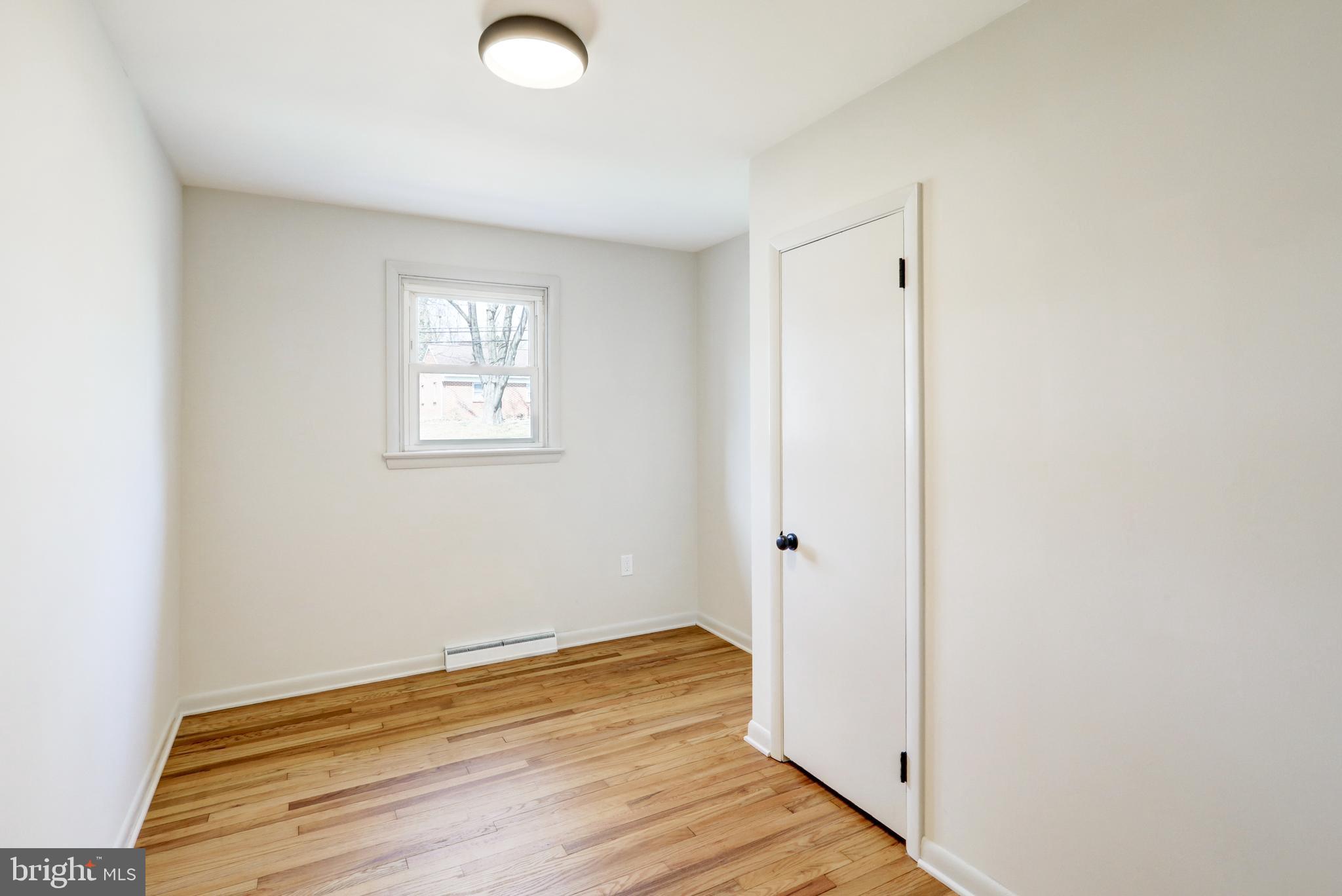 254 Blue Rock Road Millersville, PA 17551 - Photo 12 of 40 an empty room with wooden floor and windows
