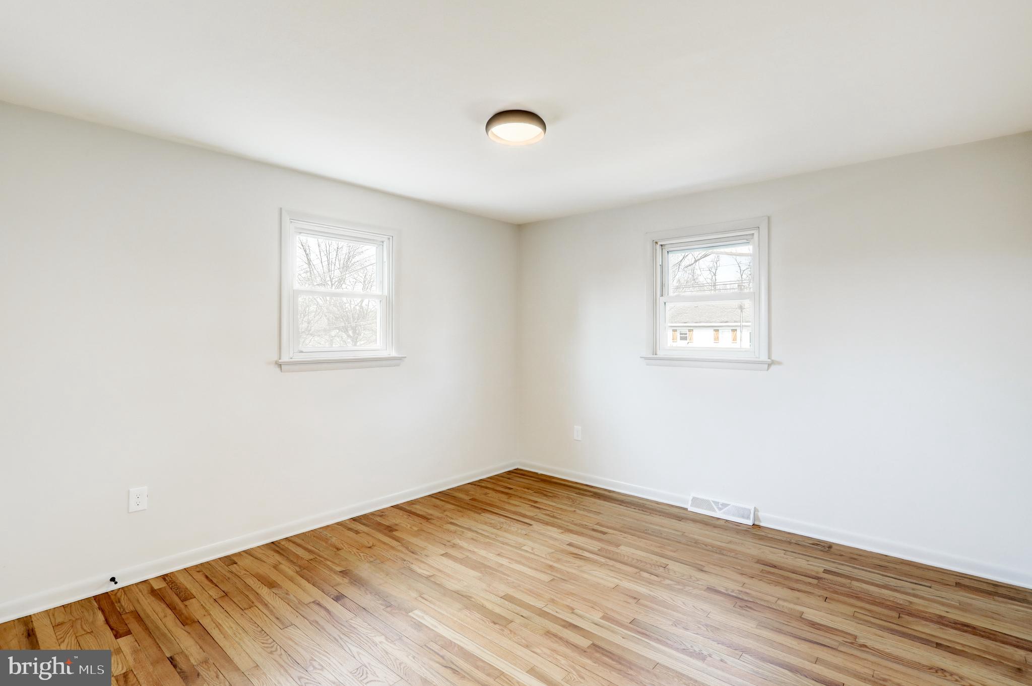 254 Blue Rock Road Millersville, PA 17551 - Photo 14 of 40 an empty room with wooden floor and windows