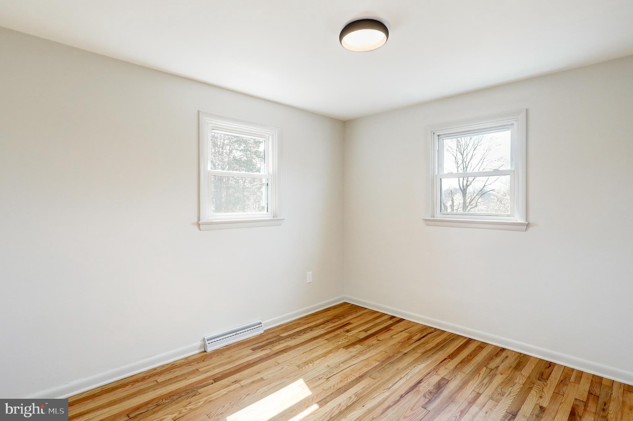 254 Blue Rock Road Millersville, PA 17551 - Photo 16 of 40 an empty room with wooden floor and windows