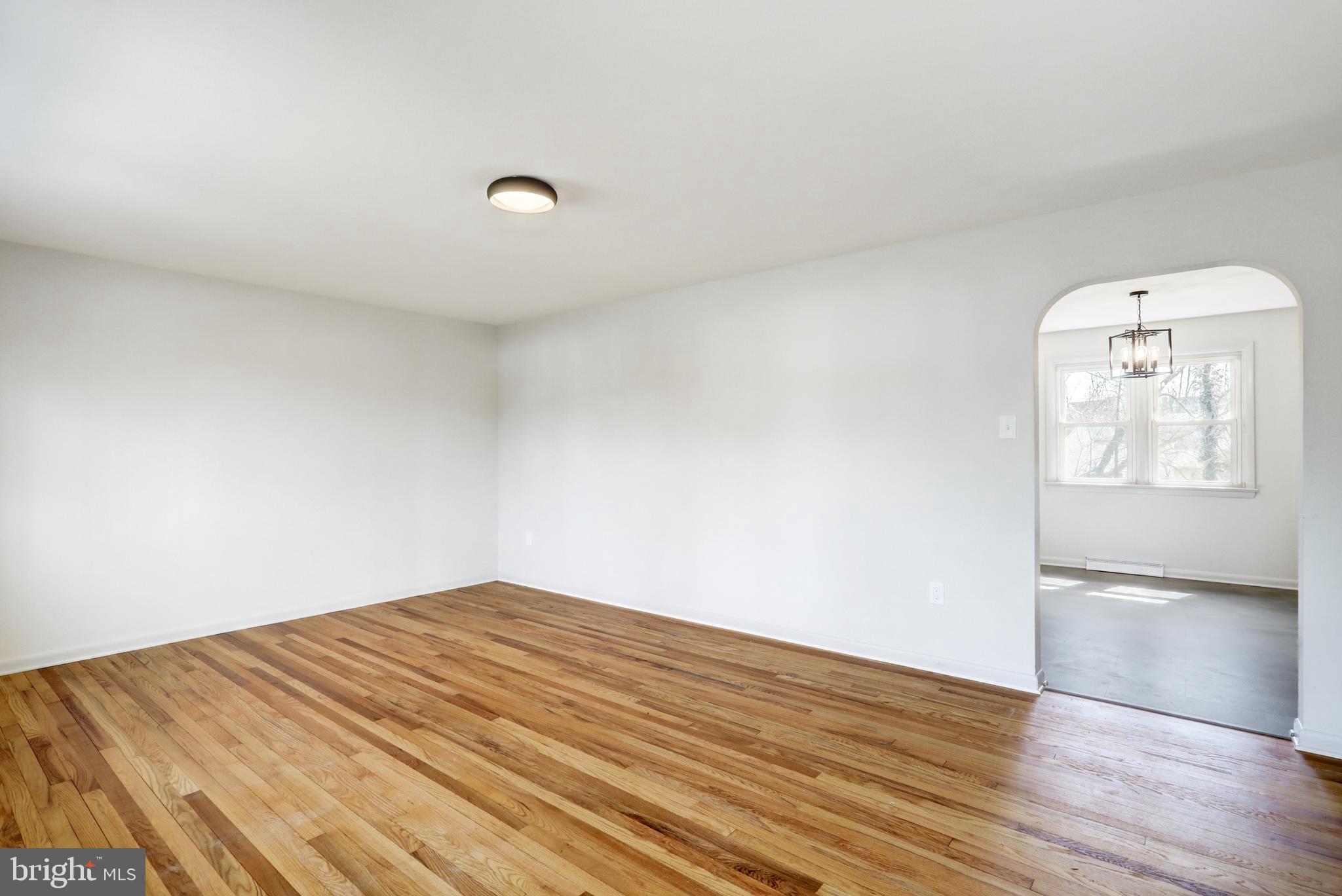 254 Blue Rock Road Millersville, PA 17551 - Photo 2 of 40 an empty room with wooden floor and windows