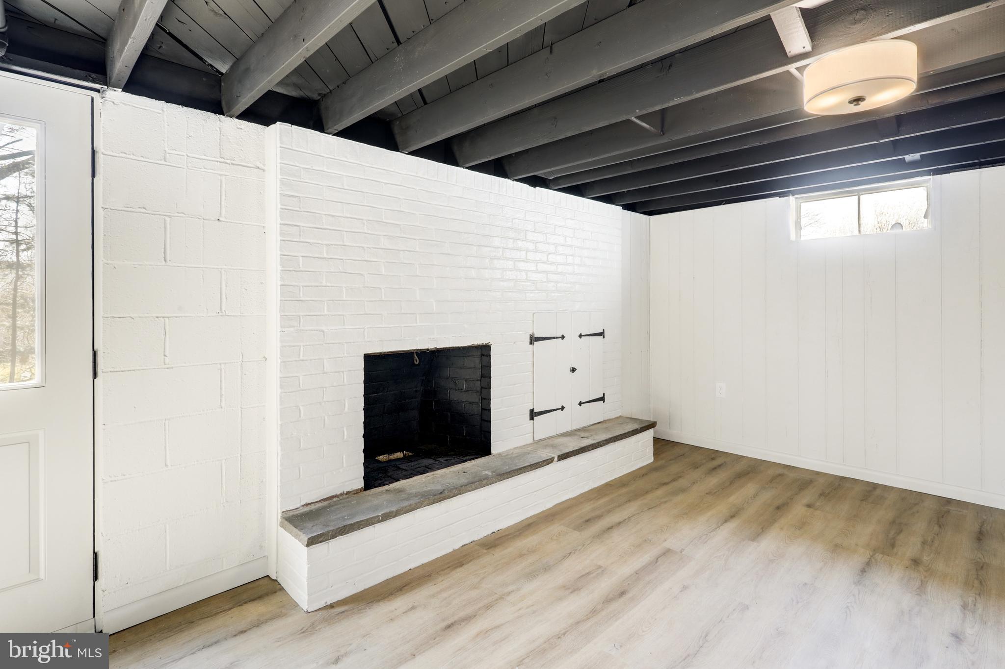 254 Blue Rock Road Millersville, PA 17551 - Photo 23 of 40 a view of an empty room with wooden floor and a fireplace