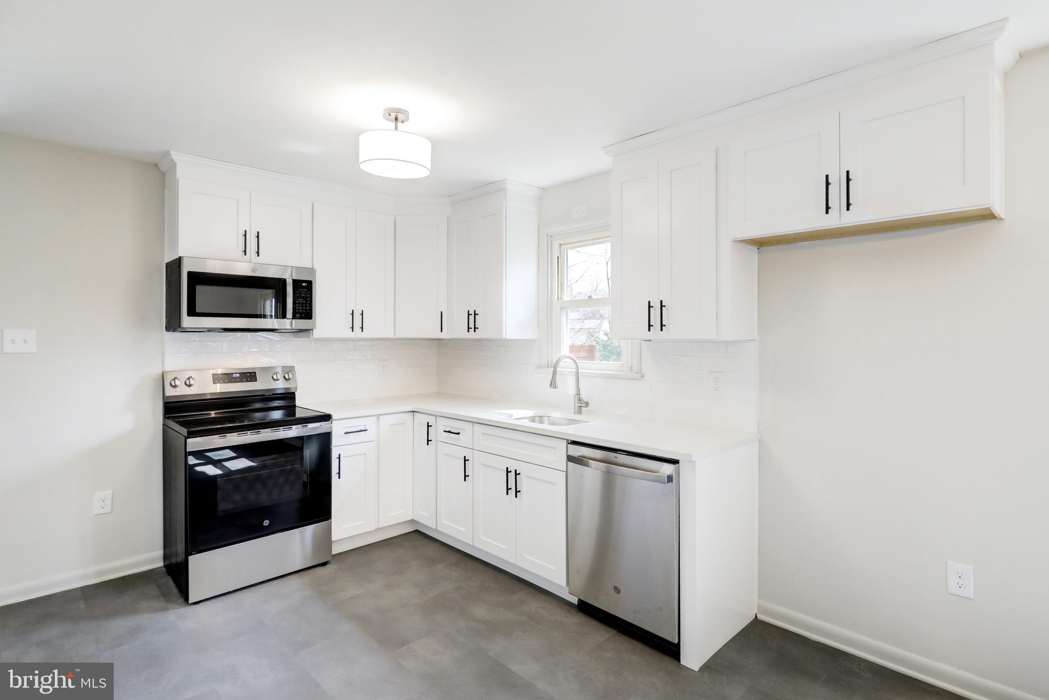 254 Blue Rock Road Millersville, PA 17551 - Photo 6 of 40 a kitchen with granite countertop white cabinets and stainless steel appliances
