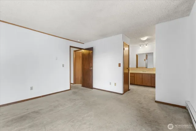 a view of a hallway with a kitchen